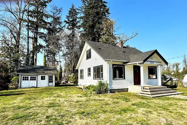 House and shop on a 2.3-acre lot, partially wooded.
