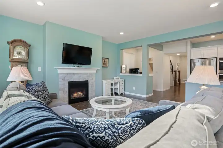 Main floor great room with a formal living room featuring a gas fireplace opens to the kitchen and dining room with sliding door to the back deck with Cascade Mountain views and southern exposure.