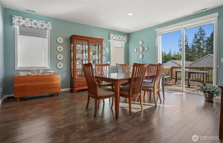 Main floor great room formal dining area with sliding door to the back deck featuring Cascade Mountain views and southern exposure.   Opens to the living room and kitchen.