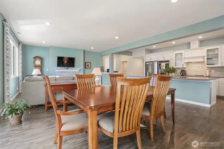 Main floor great room formal dining area with sliding door to the back deck featuring Cascade Mountain views and southern exposure.   Opens to the living room and kitchen.