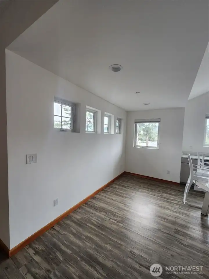 Vaulted ceiling and windows for natural light in the upper 2 bed/2 bath units. This shows area adjacent to full kitchen.