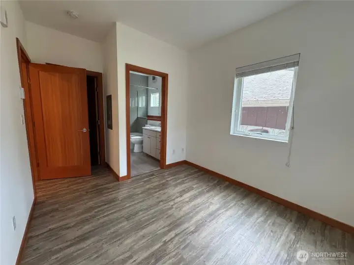 Lower 1 bedroom bath adjacent to bedroom, walk-in closet.