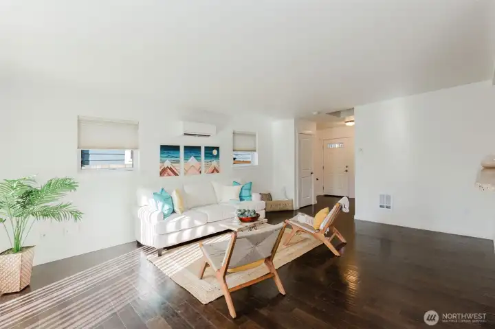 Light and bright open concept living room w/ mini-split for easy climate control.