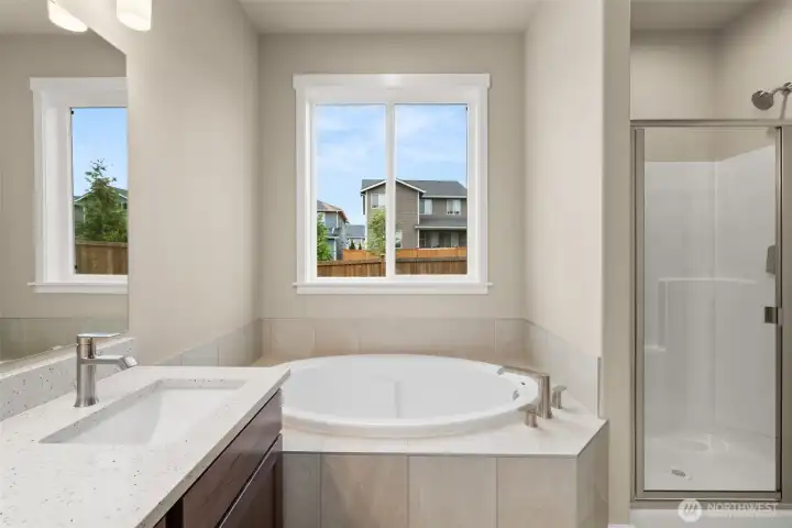 Primary bathroom offers a standard walk-in shower with glass door and a separate, private water closet