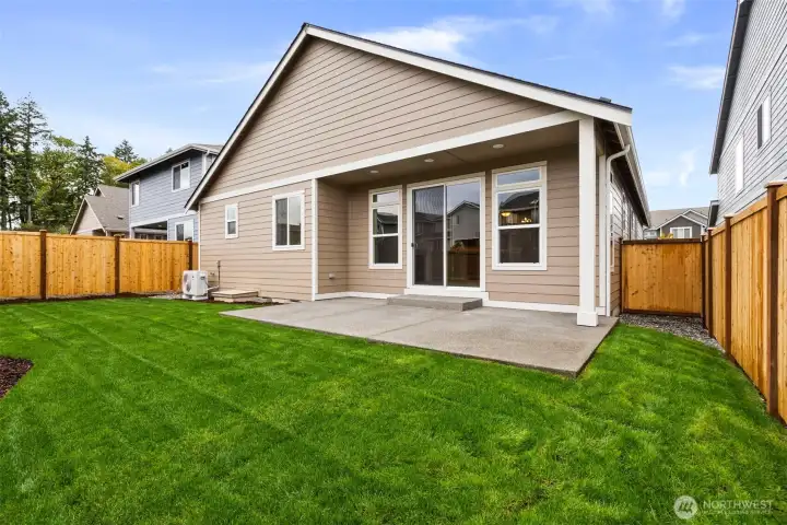 Fully landscaped backyard with privacy fencing, patio and easy access to front yard through side gate