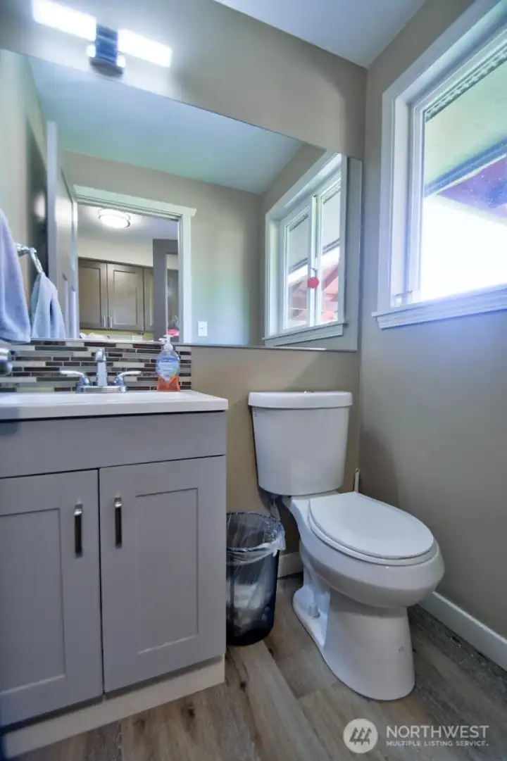 Powder bathroom across the utility room just located on the left before you go to the garage