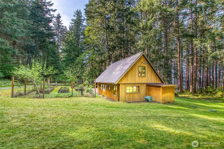 Sunny field surrounds the "barn" cabin at 64 Barn Owl.