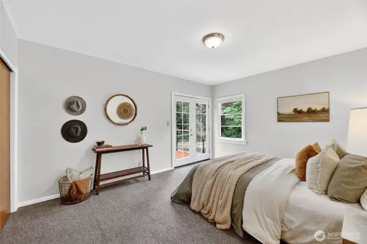 Primary bedroom. French doors lead out to the wrap around deck.