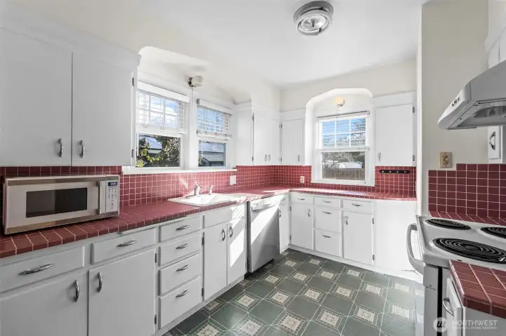Vintage Kitchen: This bright, spacious kitchen brings a pop of personality with tile countertops and classic white cabinetry. With plenty of prep space and vintage charm, it’s a delightful space for the home chef.