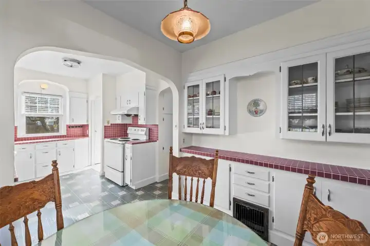 Leaded Glass Built-ins: The breakfast area includes beautiful built-in cabinetry with leaded glass doors, offering both elegant display space and practical storage that stays true to the home's period roots.