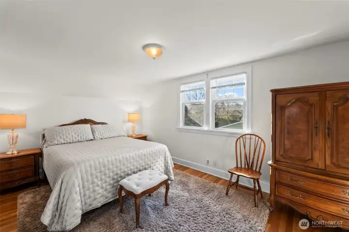Primary Bedroom: The spacious primary is a peaceful retreat offering ample room for large furniture pieces and accented by beautiful hardwood floors.
