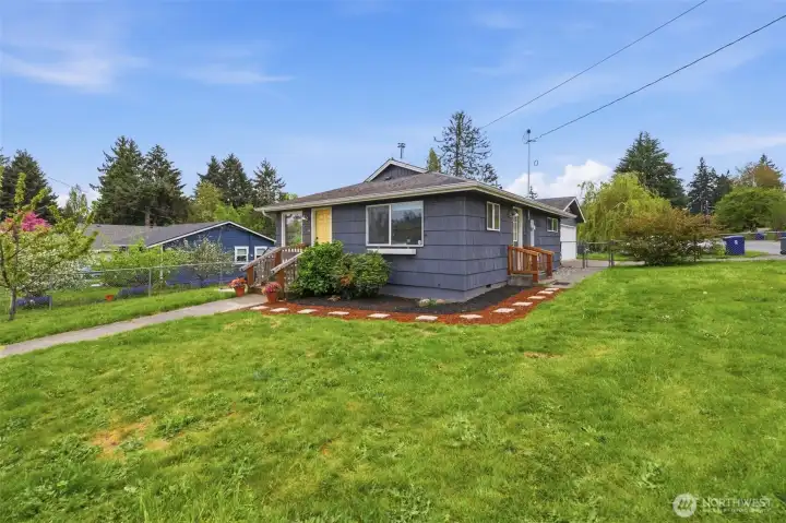 Expansive front yard offering usable outdoor space, ideal for gardening, pets, or future landscaping potential.