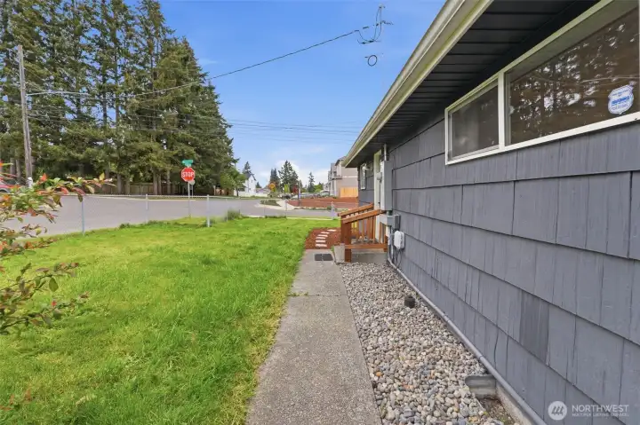 Side yard view with low-maintenance exterior and additional space for storage or outdoor use.