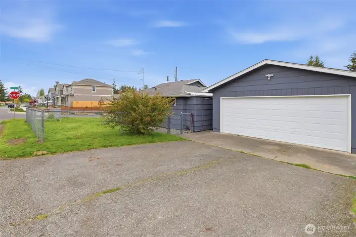 Long driveway leading to detached garage with ample off-street parking and RV parking potential.