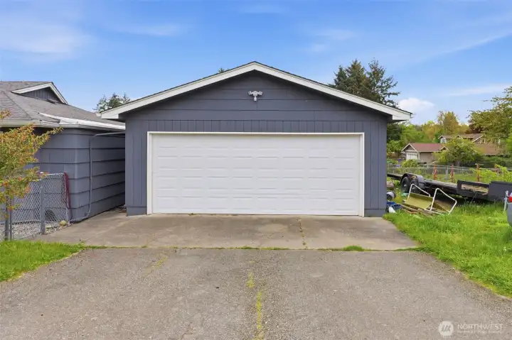 Detached garage with oversized entry, perfect for parking, storage, or workshop setup.