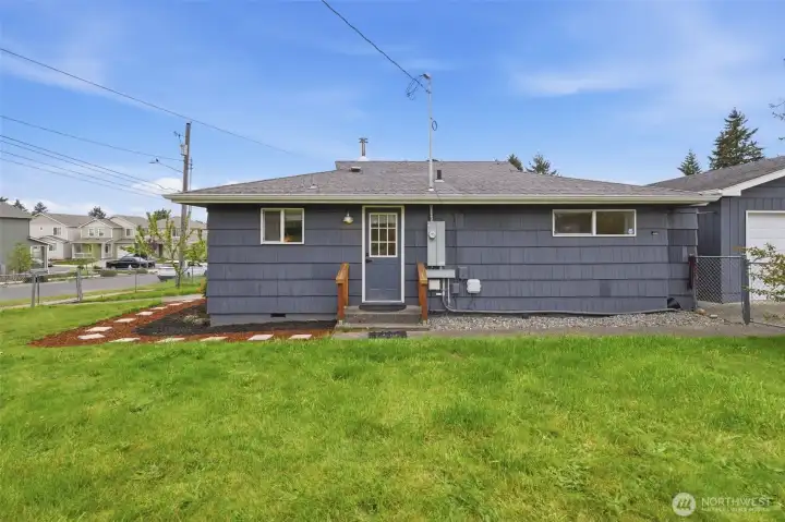 Back exterior view showcasing fully usable lot with privacy and room for outdoor living or expansion.