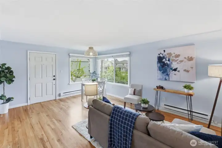 Spacious living area with large windows and seamless flow into dining space.