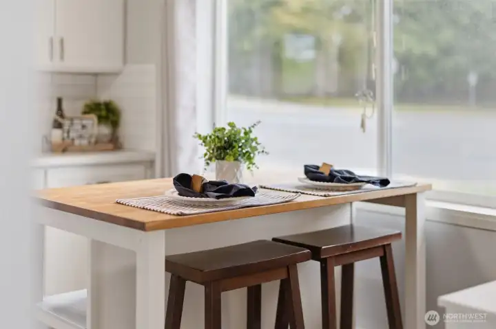 Breakfast bar with seating and natural light, perfect for casual dining.
