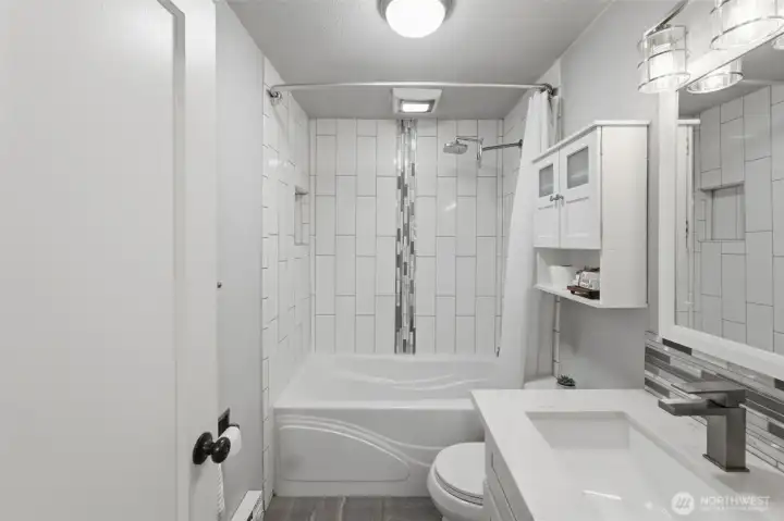 Full bathroom with tub and shower combo, neutral tones, and move-in ready condition.