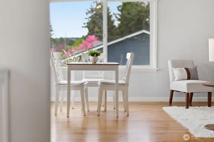 Light-filled corner space with large windows, perfect for dining or workspace.