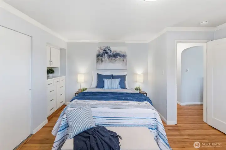Primary bedroom with hardwood floors, natural light, and comfortable layout.