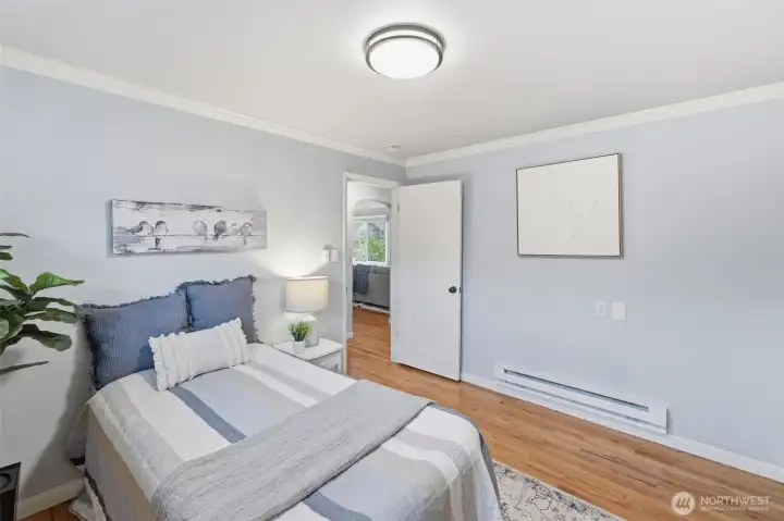 Bright bedroom with hardwood floors, natural light, and clean finishes in this Tacoma home.