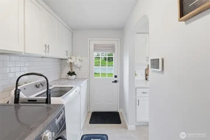 Laundry/mudroom space with exterior access, ideal for storage, cleaning, and daily functionality.