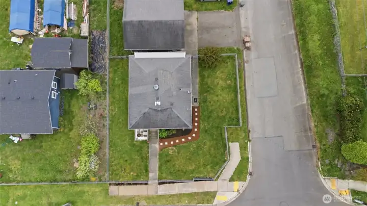 Top-down aerial showing corner lot positioning, lot size, and property boundaries.