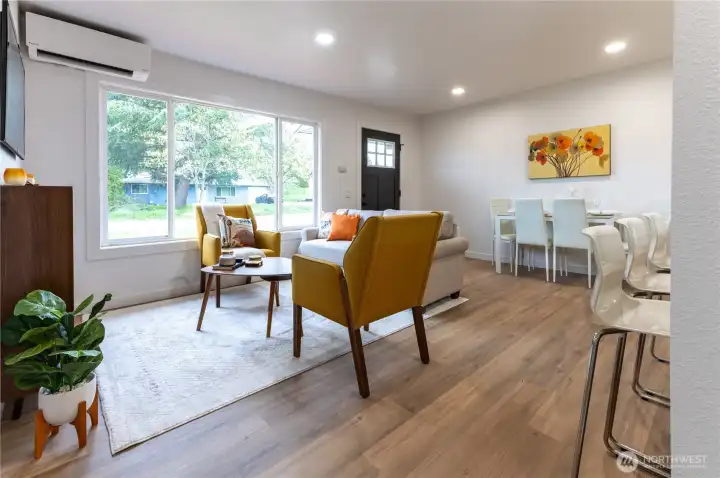 Large windows frame a picturesque view of the natural landscape found in this lovely neighborhood.