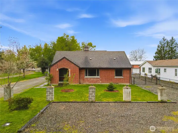 Charming brick home with classic curb appeal and a well-kept front yard with welcoming street presence.
