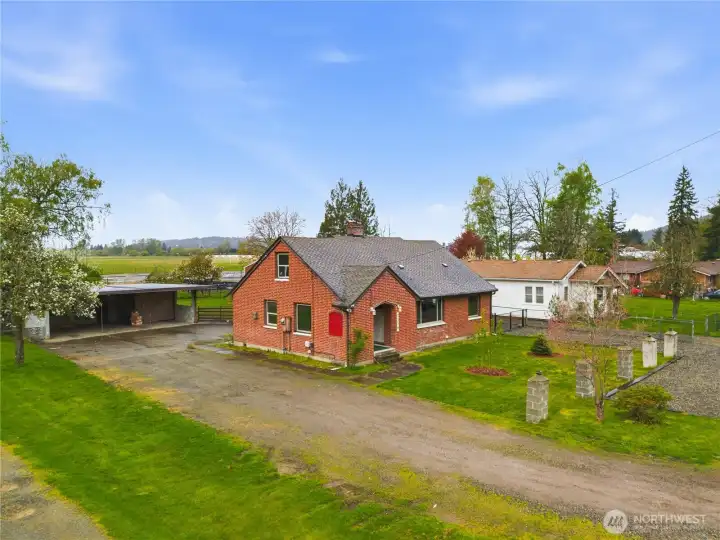 Spacious lot with a long driveway offering plenty of room to spread out, surrounded by mature landscaping.