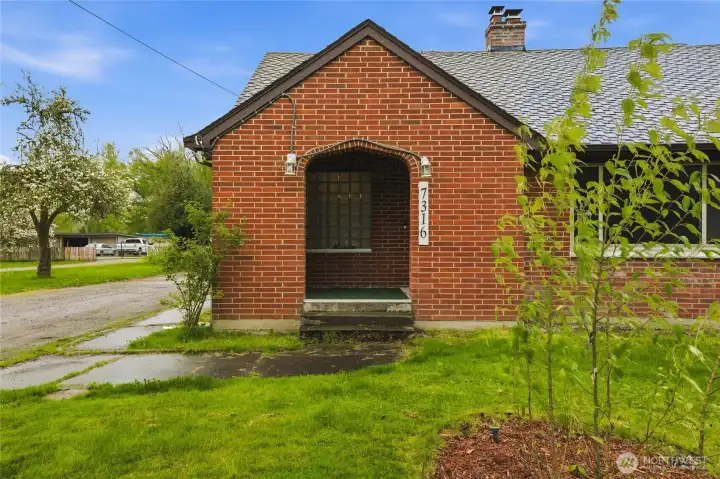 Distinctive brick exterior with an arched entryway, full of character