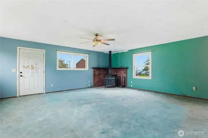 Expansive room with a wood burning stove for cozy winter nights