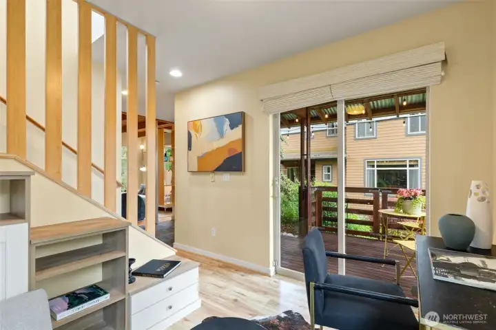 Custom shelving added to maximize the space in the den. Sliding glass door opens to the front porch.