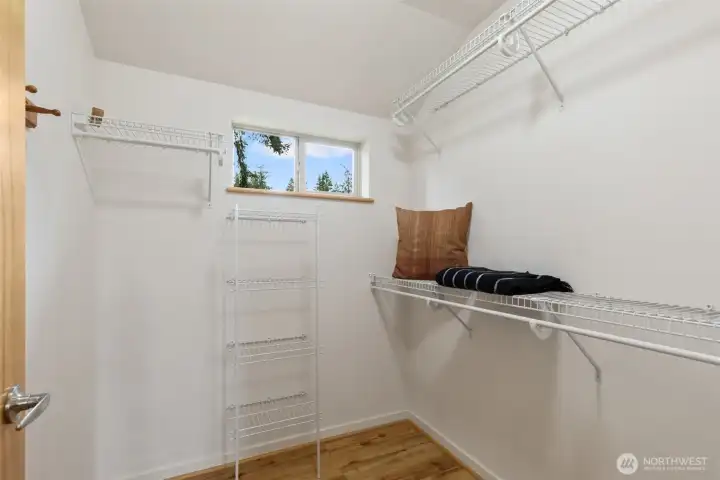 Walk-in closet off the primary bedroom. Who doesn't love a window with natural light in the closet?!