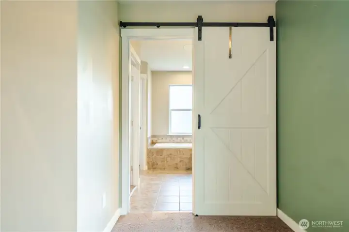Entrance to primary suite bathroom