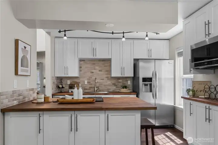 Beautiful updated kitchen with butcher block countertops.