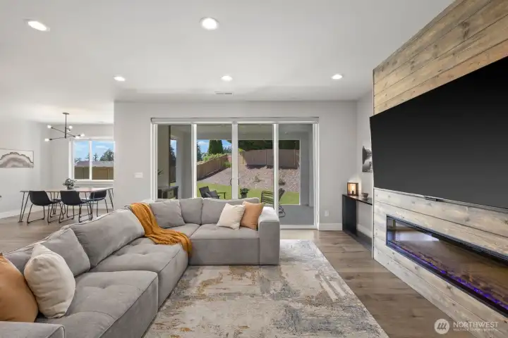 The heart of the home was designed to feel connected, with large sliding doors opening to the covered patio and backyard while the upgraded fireplace feature wall brings warmth and character to the living space. The heart of the home was designed to feel connected, with large sliding doors opening to the covered patio and backyard while the upgraded fireplace feature wall brings warmth and character to the living space.