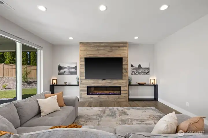 The upgraded electric fireplace with custom shiplap surround adds a custom touch that helps this home stand apart from typical builder-grade finishes, creating a clean and inviting focal point in the great room. The upgraded electric fireplace with custom shiplap surround adds a custom touch that helps this home stand apart from typical builder-grade finishes, creating a clean and inviting focal point in the great room.