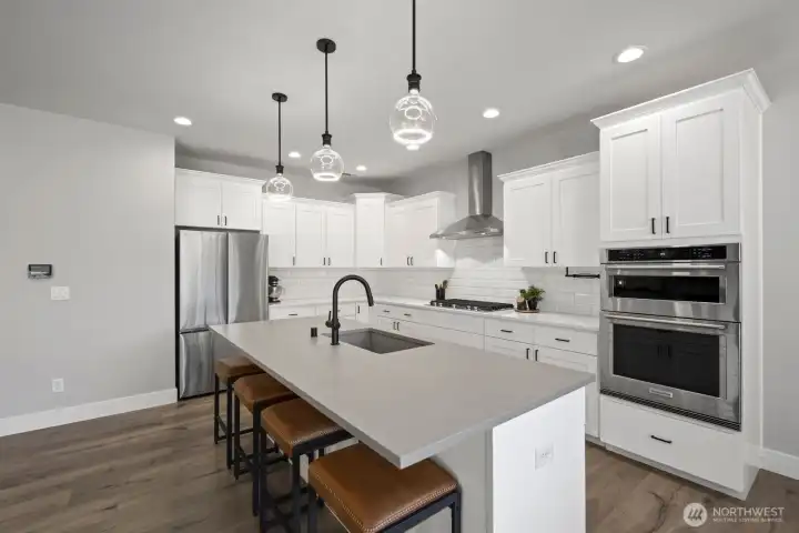 Built for both everyday living and entertaining, the kitchen features an oversized island, generous prep space, included appliances, and a walk-in pantry that helps keep everything organized and within reach. Built for both everyday living and entertaining, the kitchen features an oversized island, generous prep space, included appliances, and a walk-in pantry that helps keep everything organized and within reach.