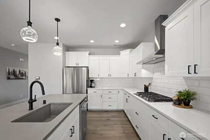 Thoughtfully designed with gathering in mind, this kitchen combines abundant storage, a spacious layout, and an oversized island that creates room to cook, prep, serve, and connect all at once. Thoughtfully designed with gathering in mind, this kitchen combines abundant storage, a spacious layout, and an oversized island that creates room to cook, prep, serve, and connect all at once.