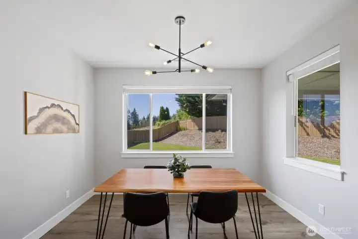 The adjacent dining area overlooks the backyard and covered patio, bringing natural light into the space and creating an easy connection between indoor and outdoor living. The adjacent dining area overlooks the backyard and covered patio, bringing natural light into the space and creating an easy connection between indoor and outdoor living.