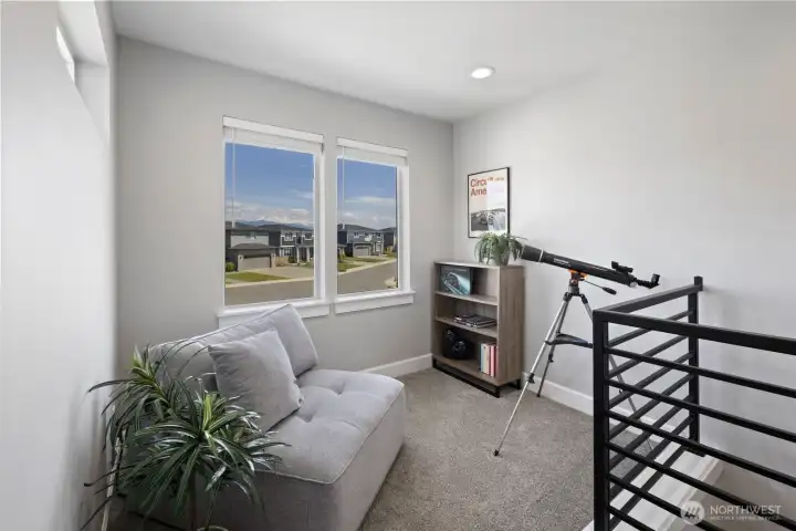 Natural light and Mount Rainier views help make the upstairs loft feel open and inviting, adding another functional gathering space beyond the main living area. Natural light and Mount Rainier views help make the upstairs loft feel open and inviting, adding another functional gathering space beyond the main living area.