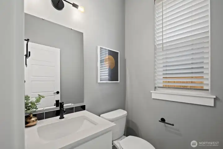Clean finishes and modern fixtures carry throughout the home, including this thoughtfully designed powder room conveniently located for guests and everyday use. Clean finishes and modern fixtures carry throughout the home, including this thoughtfully designed powder room conveniently located for guests and everyday use.