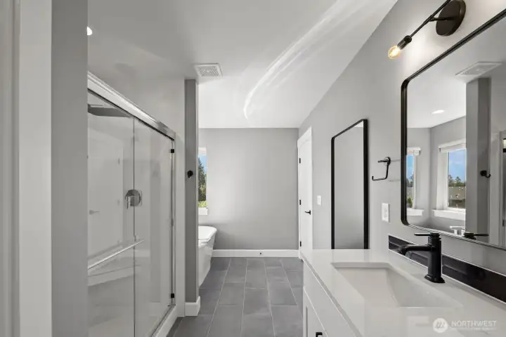 The primary bath features a clean modern design with dual vanities, oversized mirrors, and a spacious walk-in shower that gives the space a spa-like feel. The primary bath features a clean modern design with dual vanities, oversized mirrors, and a spacious walk-in shower that gives the space a spa-like feel.