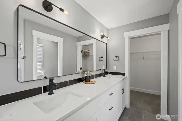 Dual sinks, modern finishes, and direct access to the walk-in closet help make the primary suite both functional and thoughtfully designed for daily living. Dual sinks, modern finishes, and direct access to the walk-in closet help make the primary suite both functional and thoughtfully designed for daily living.