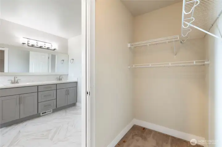 Walk-in closet in primary bathroom.