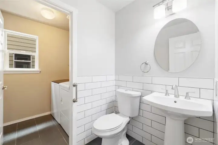 Main level half bathroom with laundry room.