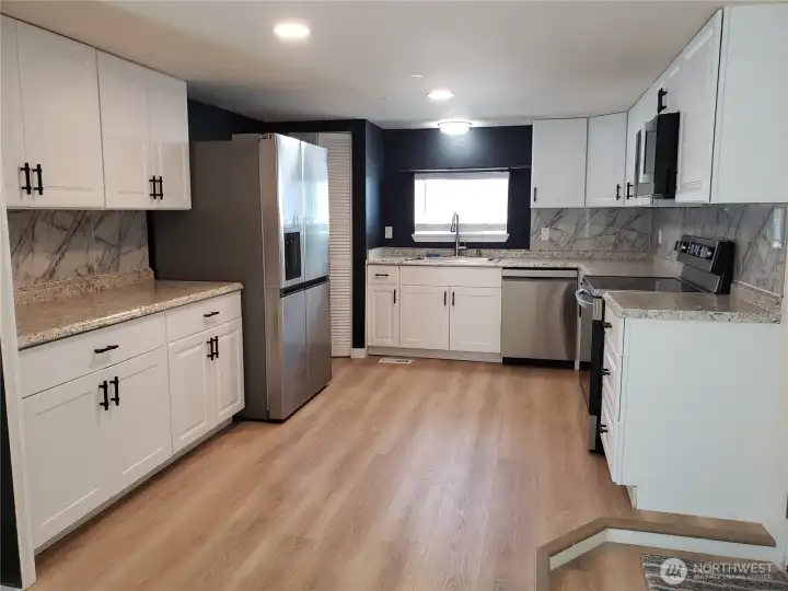 Open Bright Kitchen, New Painted White Wood Cabinets, New Counter Tops, Sink, Faucet & All New Stainless Kitchen Appliances including Built in Microwave Oven and Vinyl Plank Flooring. Open Bright Kitchen, New Painted White Wood Cabinets, New Counter Tops, Sink, Faucet & All New Stainless Kitchen Appliances including Built in Microwave Oven and Vinyl Plank Flooring.