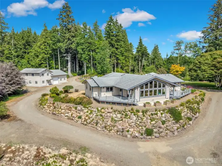 Custom-built home tucked among mature evergreens with a welcoming circular driveway. Custom-built home tucked among mature evergreens with a welcoming circular driveway.